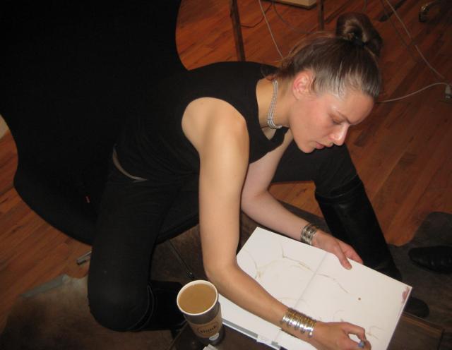 Rie sketches a line drawing..using coffee.